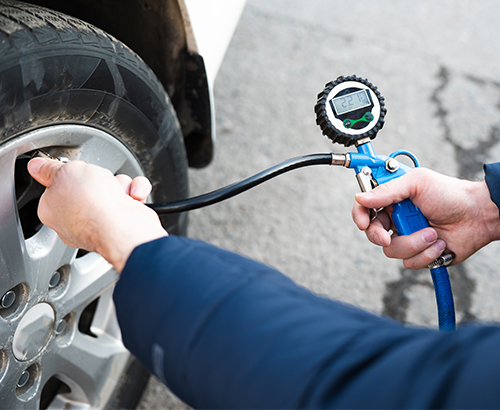 Technician Checking Tire Pressure | Hotchkiss Auto Repair
